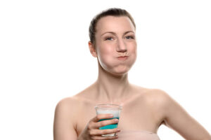 woman using mouthwash thanks to recommendations from the dentist marble falls trusts