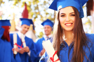 woman smiling in cap and gown