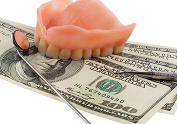 Denture dental tools and stack of money