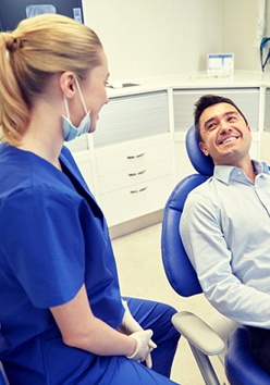 man smiling to dental hygienist