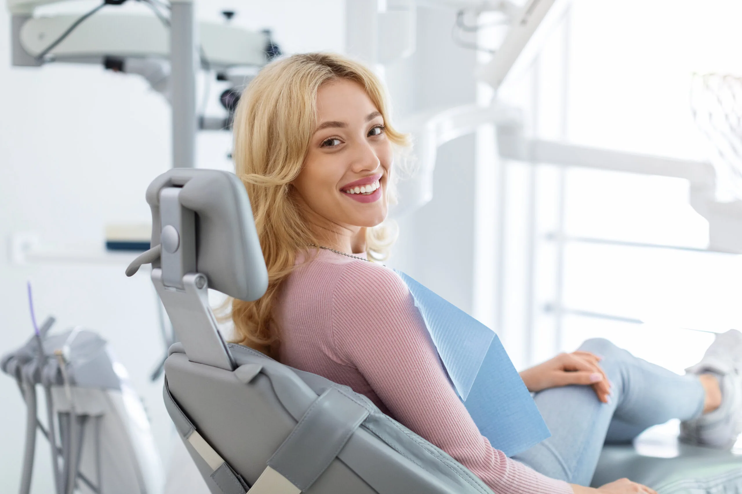 young woman smiling calmly in a modern dental office