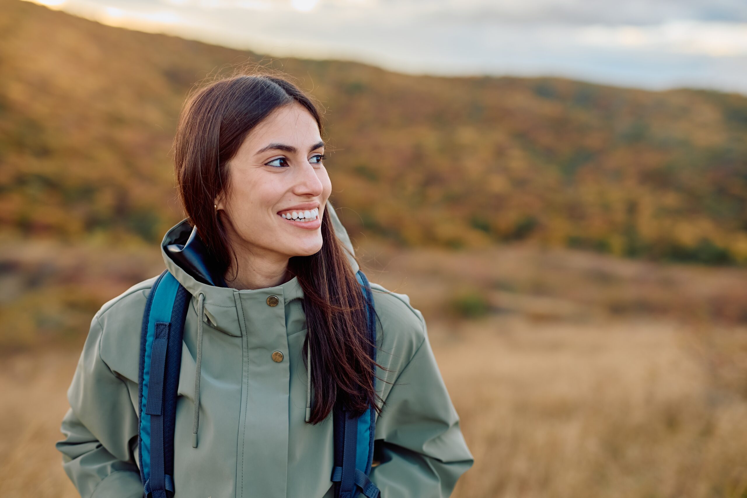 happy woman hiking outdoors, perfect white teeth