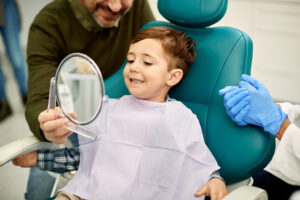 smiling little boy sitting in a dental chair